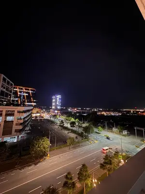 a city street at night with buildings and street lights at Namrata staycation in Manila