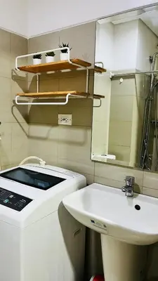 a bathroom with a sink and a mirror at Namrata staycation in Manila