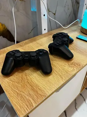 two video game controllers sitting on top of a desk at Phoenix Bliss - Amber in General Trias