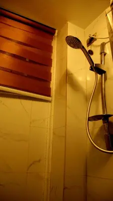 a shower with a shower head in a bathroom at Phoenix Bliss - Amber in General Trias
