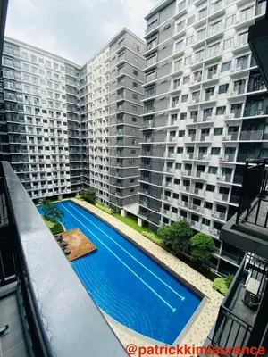 an overhead view of a large apartment building with a swimming pool at Shore 3 - 1BR Scandi-Industrial Condo Suite by The Bay in Manila