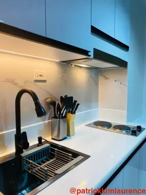 a kitchen counter with a sink and a sink at Shore 3 - 1BR Scandi-Industrial Condo Suite by The Bay in Manila
