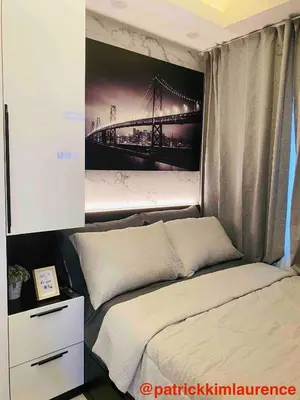 a bedroom with a bed with a picture of a bridge at Shore 3 - 1BR Scandi-Industrial Condo Suite by The Bay in Manila