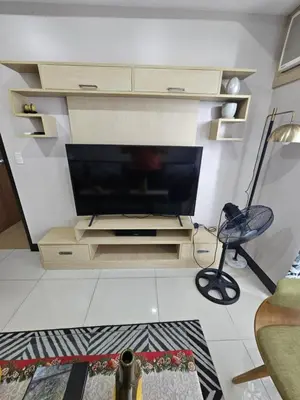 a living room with a flat screen tv on a wall at Unit 14E Tower D, 1BR Unit- Manhattan Heights Cubao in Manila