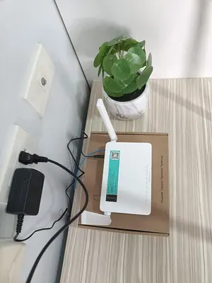a computer on a table with a box and a plant at Lyleis' Getaway in Manila