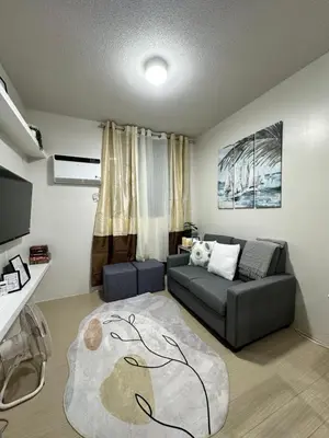 a living room with a couch and a rug at 2 bedroom unit near BGC Taguig and NAIA Airport in Manila