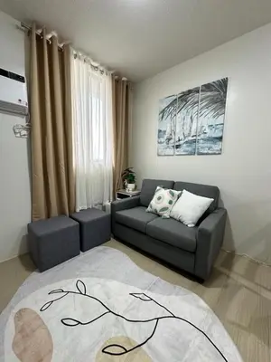 a living room with a couch and a couch and a table at 2 bedroom unit near BGC Taguig and NAIA Airport in Manila