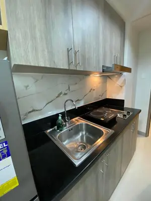 a kitchen with a sink and a counter top at Happy Sunshine Staycation Moa near Airport in Manila