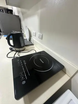 a book sitting on top of a desk with a laptop at Lugar Kalinaw in Manila
