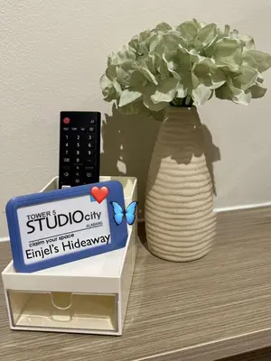 a table with a vase with a remote control and a box at Einjel's Hideaway in Manila