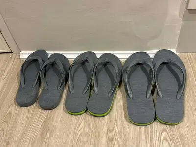 four pairs of shoes lined up against a wall at Einjel's Hideaway in Manila