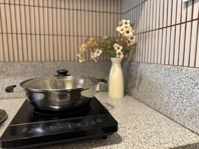 a pot on top of a stove with a vase at Einjel's Hideaway in Manila