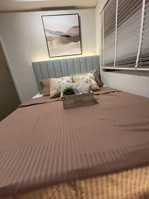 a bedroom with a large bed with a box on it at Einjel's Hideaway in Manila