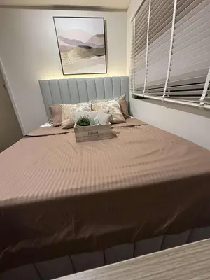 a large bed with a box on it in a bedroom at Einjel's Hideaway in Manila