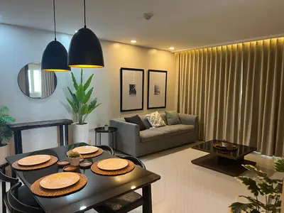 a living room with a table and a couch at Newport City Rentals in Manila