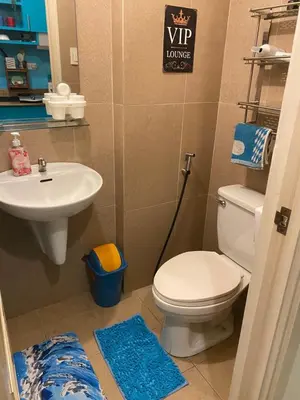 a bathroom with a toilet and a sink at The Teal Deal in Manila