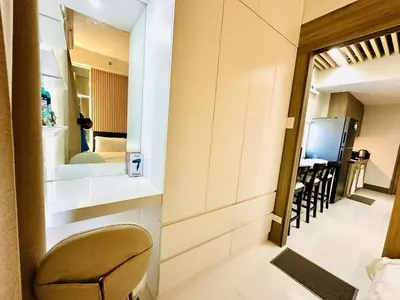 a chair sitting in a room with a mirror at Royal Fame Residency in Manila