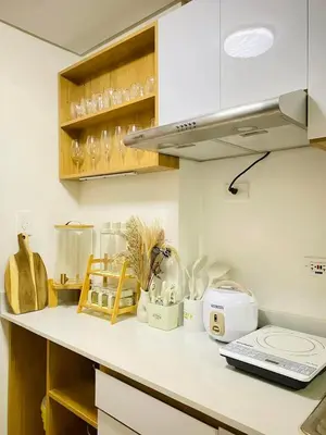 a kitchen with a white counter top with appliances at Staycation by Mailine in Manila