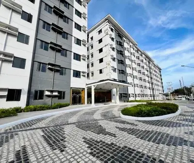 an empty street in front of two tall buildings at Staycation by Mailine in Manila
