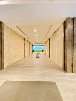 an empty hallway with a bench in the middle of a building at Staycation by Mailine in Manila
