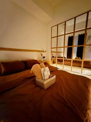 a living room with a bed with a couch at Staycation by Mailine in Manila