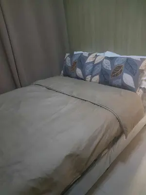 a bed with blue and white sheets and pillows at SHORE 2n3 RESIDENCES in Manila
