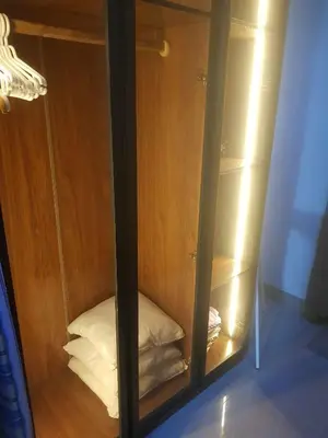 a glass cabinet with a pillow inside of it at SHORE 2n3 RESIDENCES in Manila