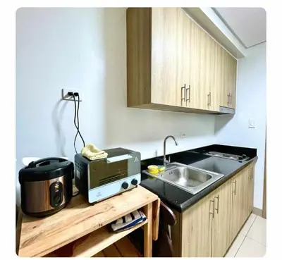 a kitchen with a sink and a toaster on a counter at SHORE 2n3 RESIDENCES in Manila