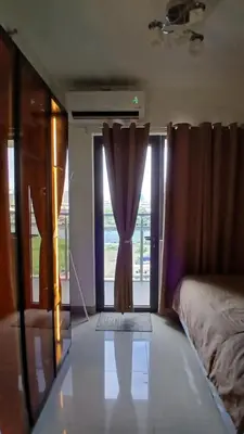 a bedroom with a bed and a window with a curtain at SHORE 2n3 RESIDENCES in Manila