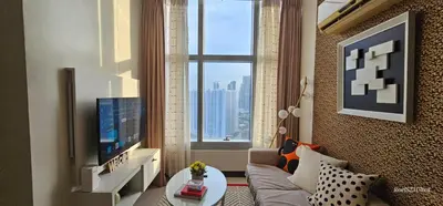 a living room with a couch and a large window at Your HOME away from home in Manila