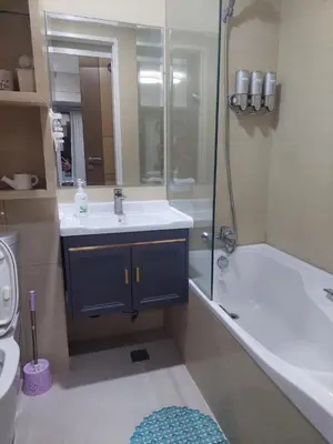 a bathroom with a tub and a sink and a shower at Your HOME away from home in Manila