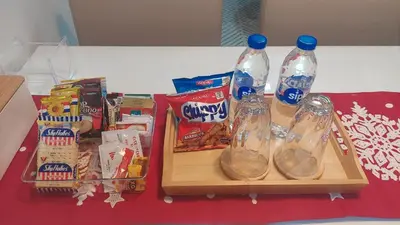 a table with two bottles of water and some snacks at Your HOME away from home in Manila