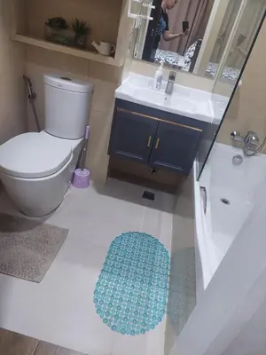 a bathroom with a toilet and a sink and a mirror at Your HOME away from home in Manila