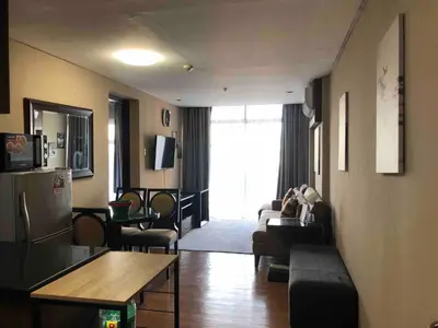 a living room with a couch and a table at A Venue Residences Tower 12L in Manila