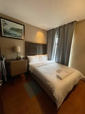 a bedroom with a large bed and a window at A Venue Residences Tower 12L in Manila