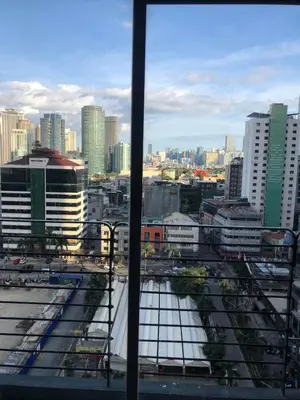 a view of a city from a window at A Venue Residences Tower 12L in Manila