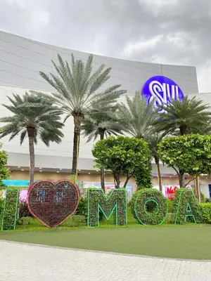 a sign in front of a mall with palm trees at Shore 3 - Unit Chloe - Brand New and Relaxing 1BR in Manila