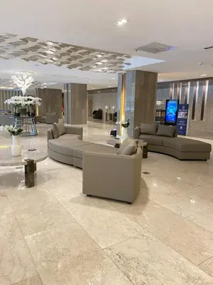 a lobby with couches and tables in a building at Shore 3 - Unit Chloe - Brand New and Relaxing 1BR in Manila