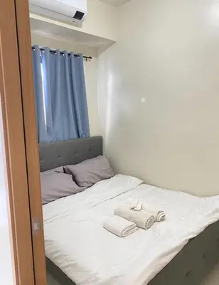 a bedroom with a bed with towels on it at Shore 3 - Unit Diva - Brand New 1 br Unit Near MOA in Manila