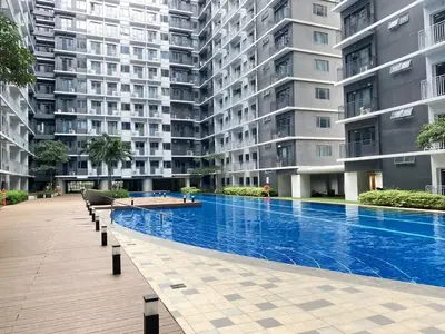 a large apartment building with a large swimming pool at Shore 3 - Unit Diva - Brand New 1 br Unit Near MOA in Manila