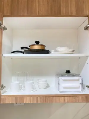a shelf with cups and plates and a pot at Shore 3 - Unit Diva - Brand New 1 br Unit Near MOA in Manila