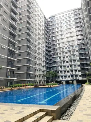 a swimming pool in front of two large apartment buildings at Shore 3 - Unit Diva - Brand New 1 br Unit Near MOA in Manila