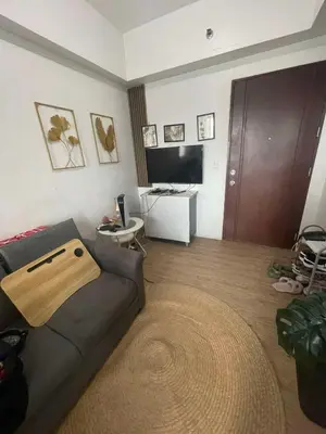 a living room with a couch and a table at Anuva Staycation by Gina in Manila