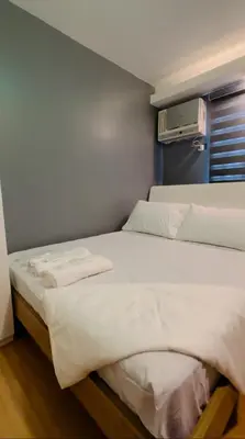 a bedroom with two beds with white sheets at H&D Suites-Memories are personal in Anabu Primero