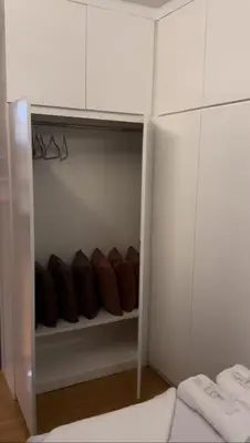 a white closet with brown shoes in it at H&D Suites-Memories are personal in Anabu Primero