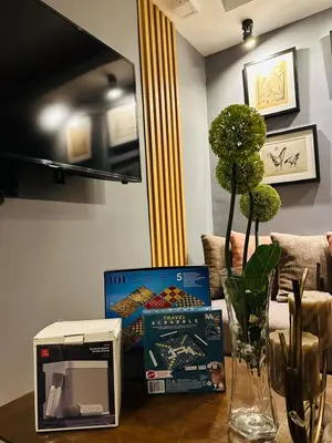 a table with books and a box on it at H&D Suites-Memories are personal in Anabu Primero