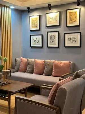 a living room with a couch against a wall at H&D Suites-Memories are personal in Anabu Primero