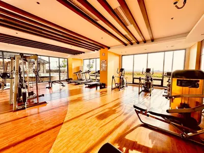 a gym with treadmills and exercise equipment in a room at New Condo at Grand Riviera Suites across US Embassy in Manila