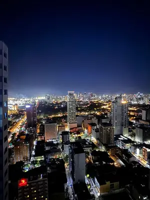 a view of a city at night at New Condo at Grand Riviera Suites across US Embassy in Manila