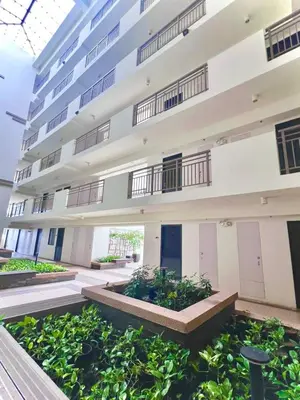 an apartment building with plants in the courtyard at Calathea Luxe Atrium Suite in Manila